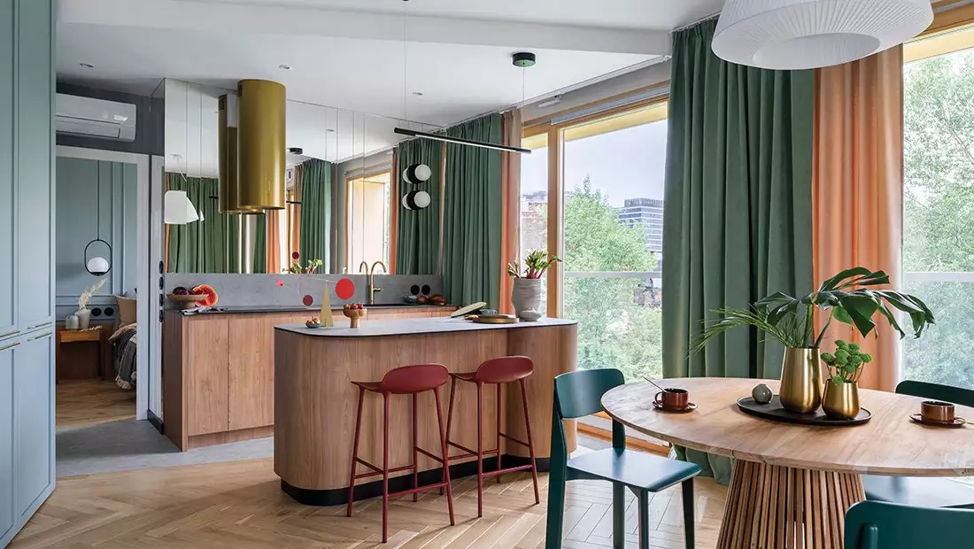 Earthy-Designed Dining Area featuring Green Curtains and Warm Wood Table and Cabinet/Countertop